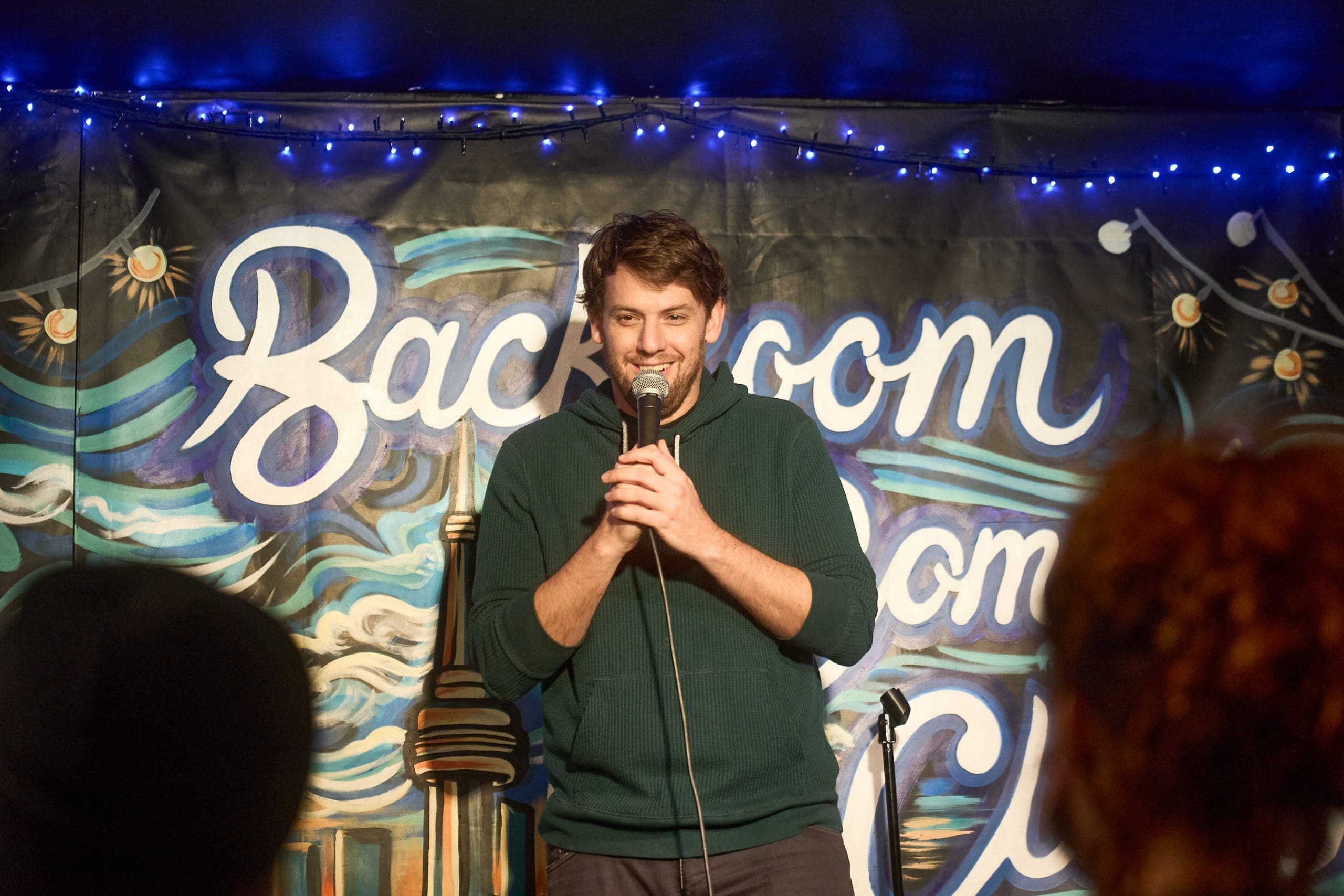 Ariel Kagan on stage at Backroom Comedy Club
